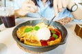 Beautiful young Asian woman enjoy eating homemade fruits pancakes with banana, strawberry, ice cream and iced coffee. Delicious sw Royalty Free Stock Photo