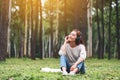 A beautiful woman enjoy listening to music with headphone with feeling happy and relaxed in the park Royalty Free Stock Photo