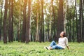 A beautiful woman enjoy listening to music with headphone with feeling happy and relaxed in the park Royalty Free Stock Photo