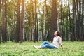 A beautiful woman enjoy listening to music with headphone with feeling happy and relaxed in the park Royalty Free Stock Photo