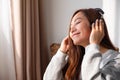 A beautiful young asian woman enjoy listening to music with headphone at home Royalty Free Stock Photo