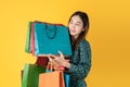 Beautiful young Asian woman excited with discount products on sale happy shopping many bags, portrait young attractive lady hold Royalty Free Stock Photo