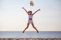 beautiful young asian woman excited throwing hats up on the air at the sea beach . Happy girl enjoy holidays vacation .