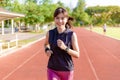 Beautiful young Asian woman exercising in the morning at a running track