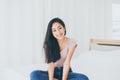 Beautiful young asian woman happy and smiling face and looking to camera while sitting in bedroom Royalty Free Stock Photo