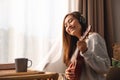 A beautiful young woman with headphone enjoy playing an ukulele at home Royalty Free Stock Photo