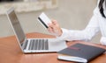 Beautiful young asian woman holding a credit card and shopping online with using laptop computer at cafe Royalty Free Stock Photo