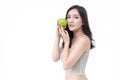 Beautiful young Asian woman holding green apple and looking at camera isolated over white background. Healthy Concept Royalty Free Stock Photo