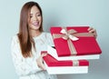 Beautiful young asian woman holding a present