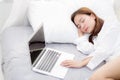 Beautiful young asian woman with laptop lying down in bedroom, girl tired sleep with computer notebook. Royalty Free Stock Photo