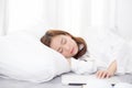 Beautiful young asian woman with laptop lying down in bedroom, girl tired sleep with computer notebook Royalty Free Stock Photo