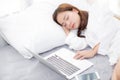 Beautiful young asian woman with laptop lying down in bedroom Royalty Free Stock Photo