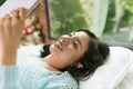 Beautiful young asian woman laying on bed and writing a diary Royalty Free Stock Photo