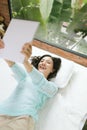 Beautiful young asian woman laying on bed and writing a diary Royalty Free Stock Photo