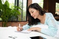 Beautiful young asian woman laying on bed and writing a diary Royalty Free Stock Photo