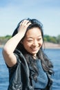 Beautiful young Asian woman smiling in the city at sunny day Royalty Free Stock Photo