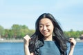 Beautiful young Asian woman with long black hair smiling at sunny day Royalty Free Stock Photo