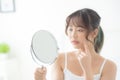 Beautiful young asian woman looking the mirror with acne problem at bedroom, trouble of beauty on face, zit treatment Royalty Free Stock Photo