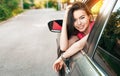 Beautiful young asian woman looks out of the car window. Royalty Free Stock Photo