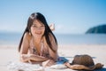 Beautiful Young Asian woman lying on beach happy relax near sea. Lifestyle women travel on beach concept Royalty Free Stock Photo