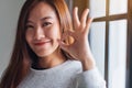 A beautiful young asian woman making and showing ok hand sign Royalty Free Stock Photo