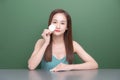 Beautiful young Asian woman with perfect skin removes make up with cotton pad, face cleaning concept Royalty Free Stock Photo