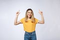 Beautiful young Asian woman pointing her finger up with cheerful expression, on white background. Royalty Free Stock Photo