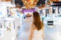 Beautiful young Asian woman with protective face mask walking at shopping center or department store, blur background, Shopping, Royalty Free Stock Photo