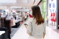 Beautiful young Asian woman with protective face mask walking at shopping center or department store, blur background, Shopping, Royalty Free Stock Photo