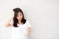 Beautiful young asian woman reading book with stress and frustrated dislike for learning and study. Royalty Free Stock Photo