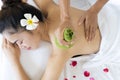 Beautiful young Asian woman relaxing during full body massage at spa environment Royalty Free Stock Photo