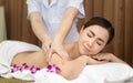 Beautiful young Asian woman relaxing with hand massage on naked back body by masseur at beauty spa treatment. relaxing massage Royalty Free Stock Photo