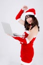 Beautiful young asian woman in Santa using working laptop computer in Christmas holiday isolated on white background Royalty Free Stock Photo