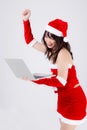 Beautiful young asian woman in Santa using working laptop computer in Christmas holiday isolated on white background Royalty Free Stock Photo