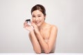 Beautiful Young Asian Woman with short hair Holding luxury cream jar smile feeling so happy and cheerful with healthy Clean and Fr Royalty Free Stock Photo