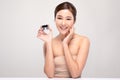 Beautiful Young Asian Woman with short hair Holding luxury cream jar smile feeling so happy and cheerful with healthy Clean and Fr Royalty Free Stock Photo