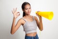 Beautiful young Asian woman show OK announce with megaphone. Royalty Free Stock Photo