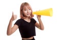 Beautiful young Asian woman show thumbs up announce with megaphone. Royalty Free Stock Photo