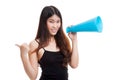 Beautiful young Asian woman show thumbs up announce with megaphone. Royalty Free Stock Photo