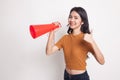 Beautiful young Asian woman show thumbs up announce with megaphone. Royalty Free Stock Photo