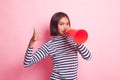 Beautiful young Asian woman show thumbs up announce with megaphone. Royalty Free Stock Photo