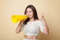 Beautiful young Asian woman show thumbs up announce with megaphone. Royalty Free Stock Photo