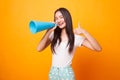 Beautiful young Asian woman show thumbs up announce with megaphone. Royalty Free Stock Photo