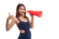 Beautiful young Asian woman show thumbs up announce with megaphone. Royalty Free Stock Photo