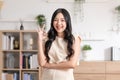 Beautiful young Asian woman showing thumbs up OK gesture smile with positive emotional at home. Attractive female making okay hand Royalty Free Stock Photo