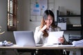 Beautiful young asian woman sitting at coffee shop using laptop. Happy young businesswoman sitting at table in cafe with tab top Royalty Free Stock Photo