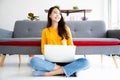 Beautiful young asian woman sitting on the floor working using computer laptop Royalty Free Stock Photo