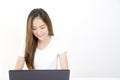 Beautiful young Asian woman sitting in front of laptop computer Royalty Free Stock Photo
