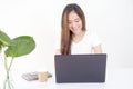 Beautiful young Asian woman sitting in front of laptop computer Royalty Free Stock Photo