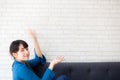 Beautiful young asian woman sitting and smiling happy and presenting something on sofa showing future or planning Royalty Free Stock Photo